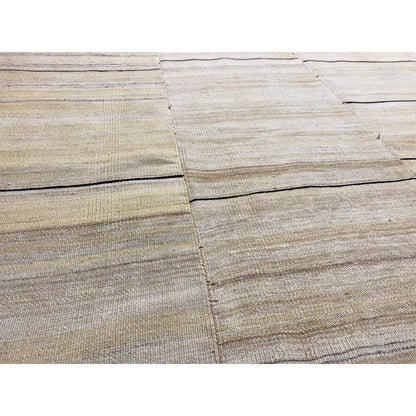 Close-up of the kilim: cream-colored fields, fine stripes, dark edges