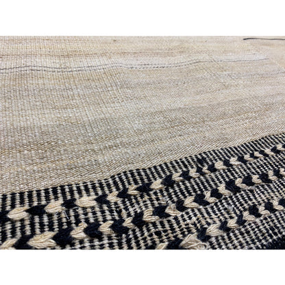 Kilim border in detail: dark gray zigzag pattern along the carpet edge