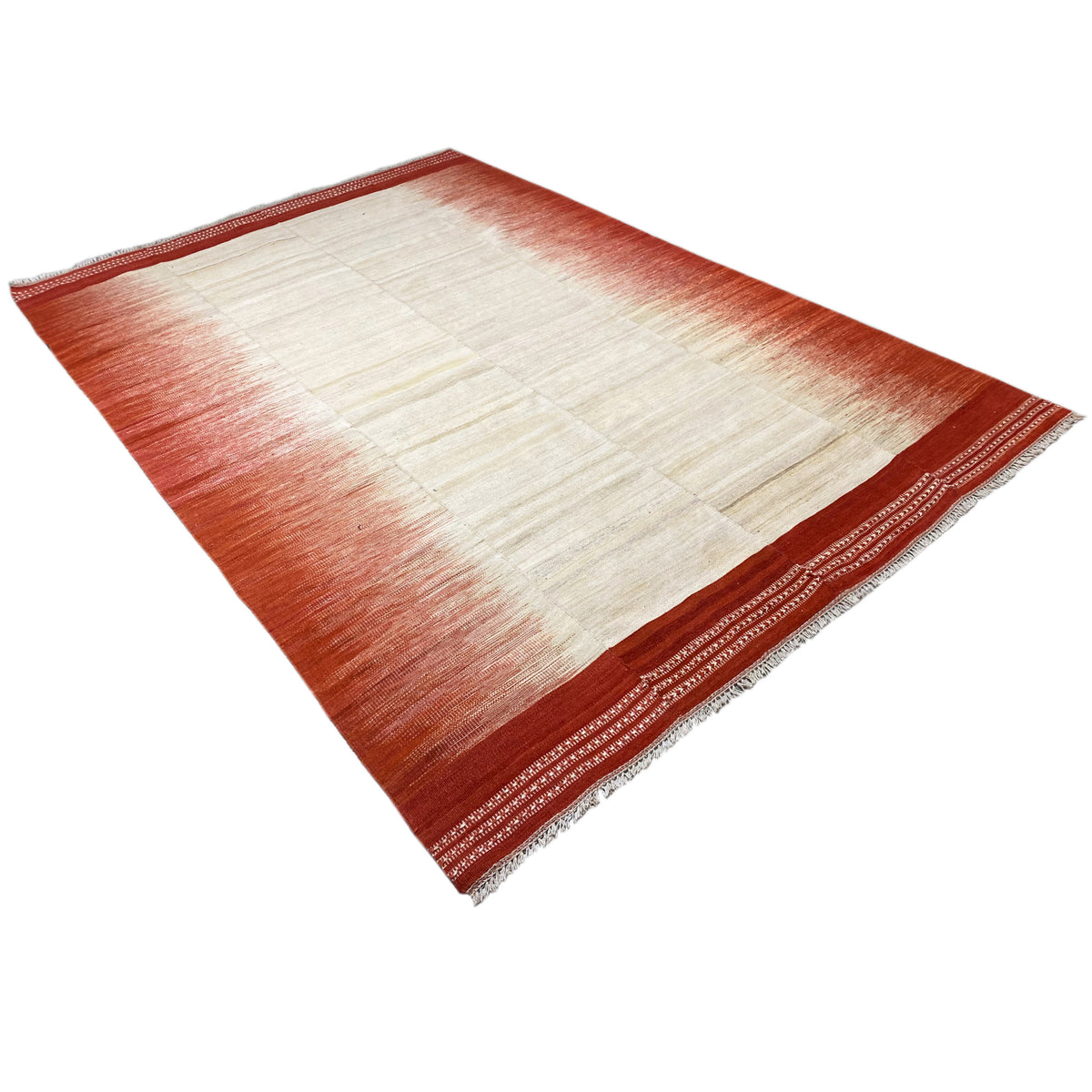 Kilim, folded view: cream-white patchwork grid, reddish-brown edges with border pattern