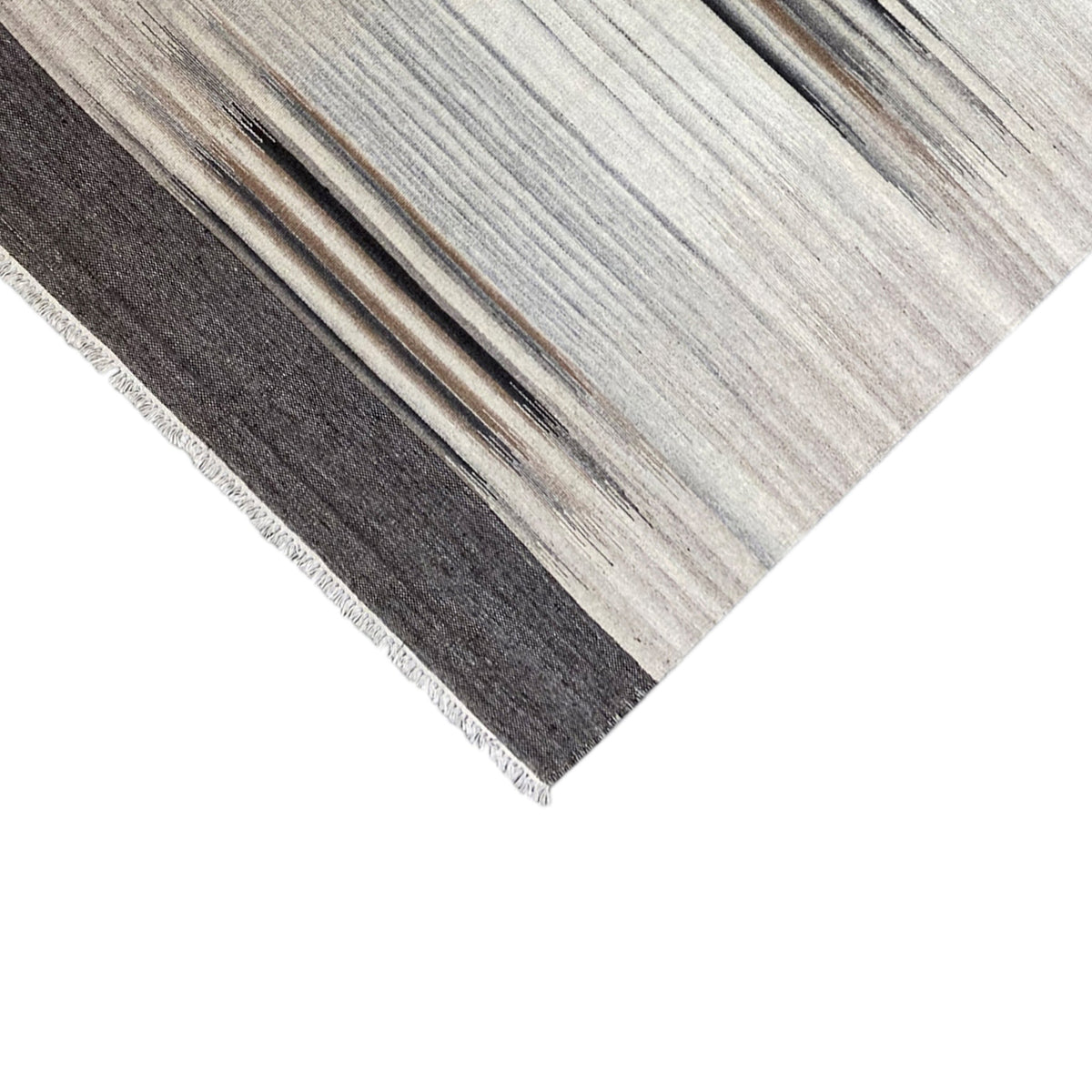 Kilim rug with a dark horizontal line, light stripes, and visible fringes
