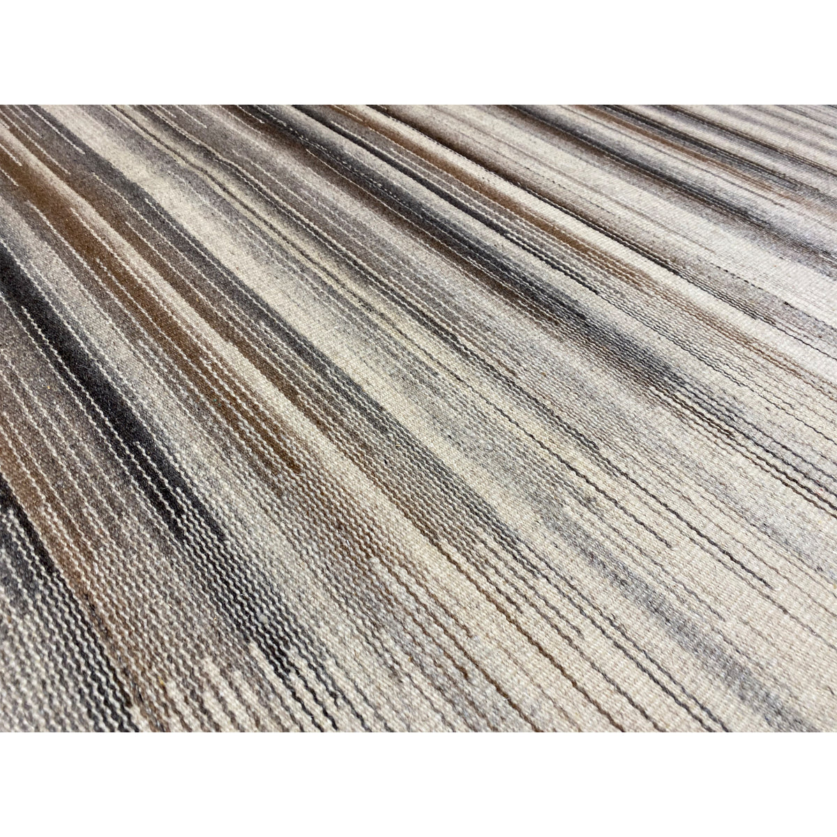 Close-up: kilim dhurrie with a fine striped pattern in gray, beige, and brown