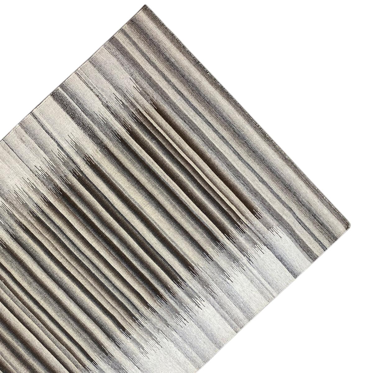 Details of the striped kilim dhurrie: gray-and-white lines, textured surface