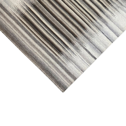 Corner area of the gray rug with stripes and fine edge finishing