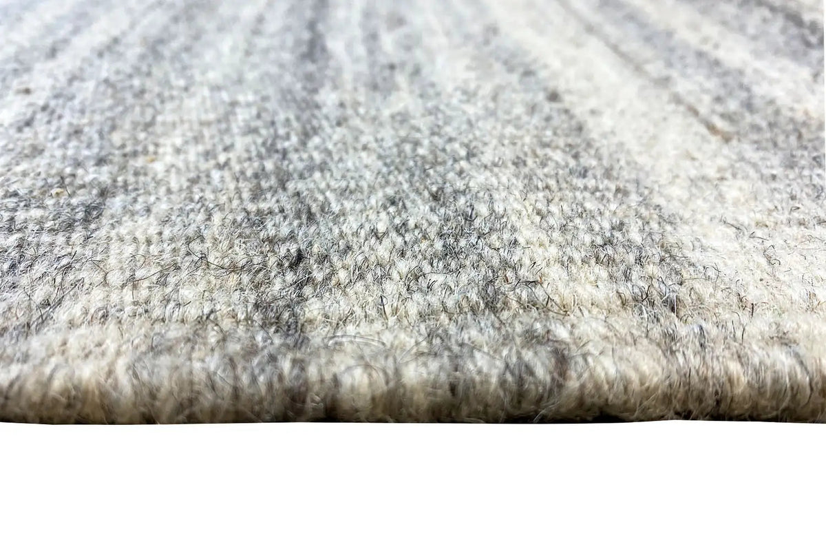 Close-up of the carpet edge with pile texture and light-dark mélange