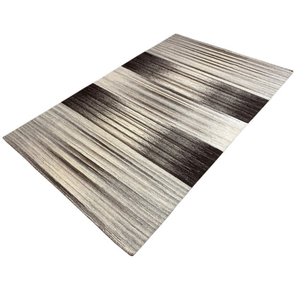 Gray kilim rug with contrasting stripes, lying flat at an angle