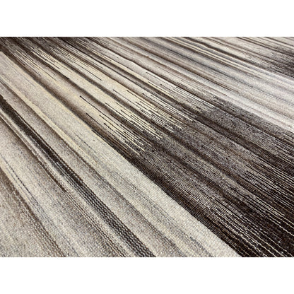 Close-up of the kilim rug: gray striped pattern with a mottled woven texture