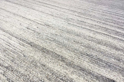 Close-up of the striped pattern: beige and gray kilim dhurrie rug