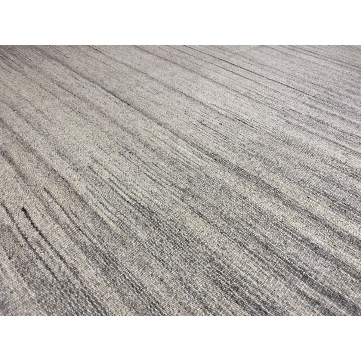 Close-up: striped kilim dhurrie rug in beige and gray with a textured surface
