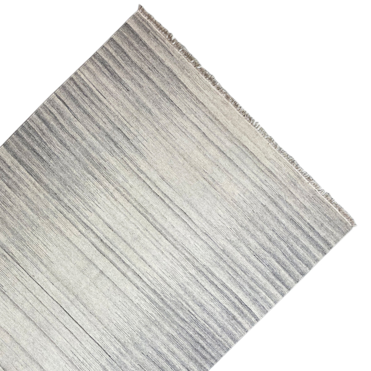 Kelim dhurrie rug detail with fine stripes and fringes along the edge