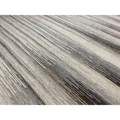 Detail of the kilim rug: fine beige and gray-brown stripes, woven texture