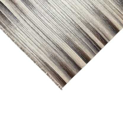 Rug edge with fringe in a beige and dark gray kilim stripe pattern