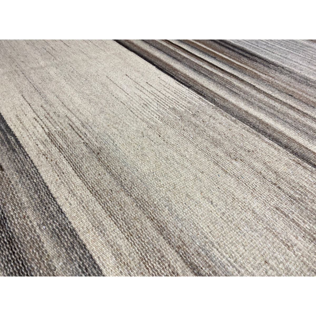 Close-up of a kilim rug: light beige stripes with gray lines