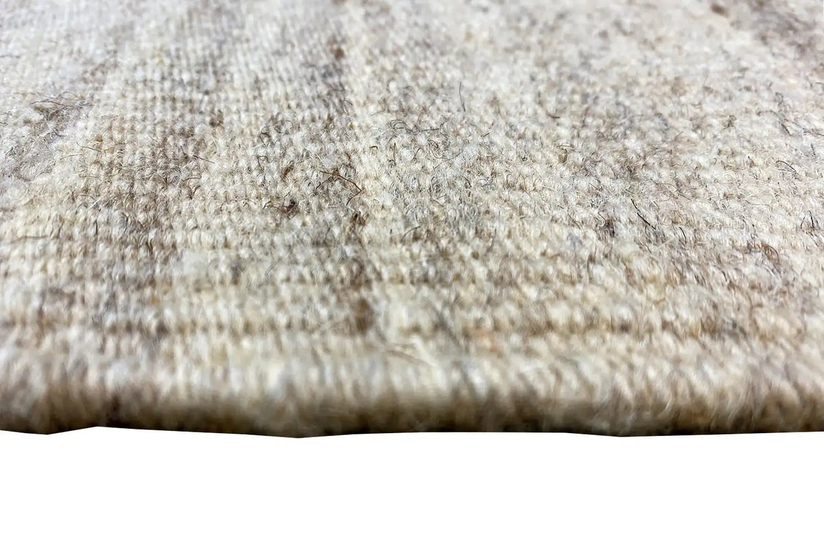 Fabric surface of the kilim rug: beige fibers with short dark weavings