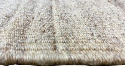 Fabric surface of the kilim rug: beige fibers with short dark weavings