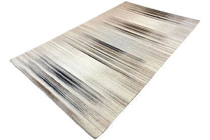 Beige kilim rug with horizontal gray stripes, photographed diagonally