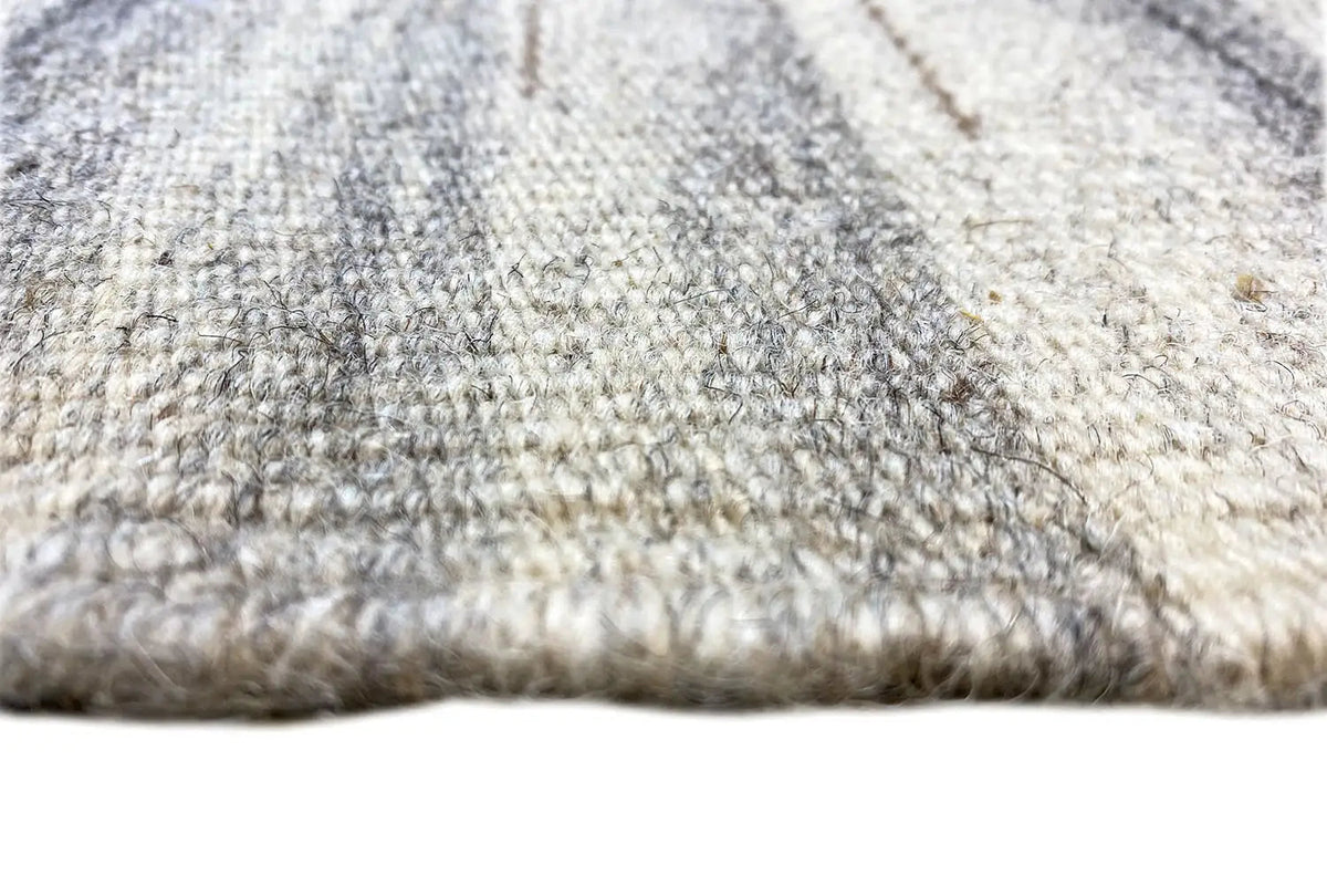 Carpet surface detail: textured braided look with light beige and gray tones