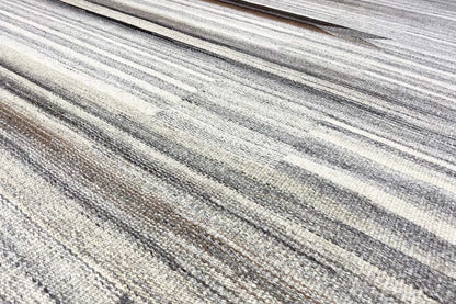 Close-up of the striped pattern on the beige and gray Kelim Dhurrie rug with darker accents