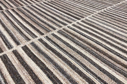 Close-up of a kilim dhurrie: woven lines in gray, brown, and beige, flat-weave