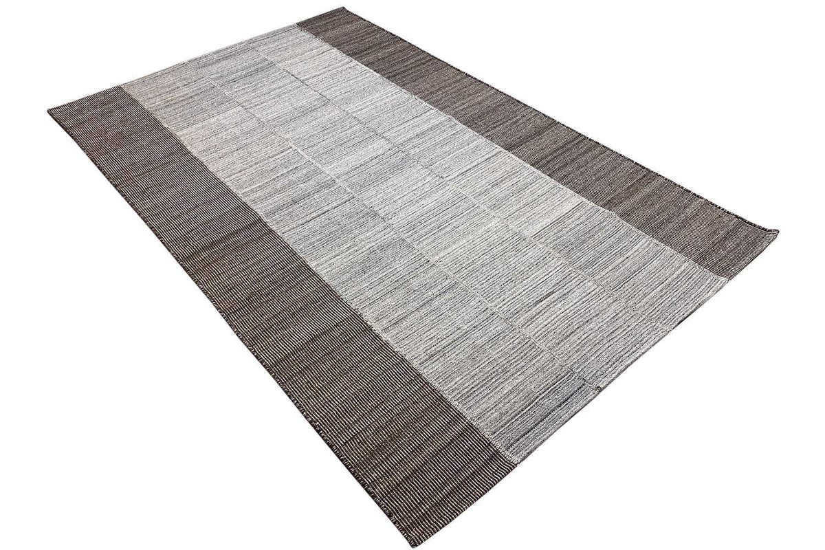 Rug with a light central band and brown-gray edges, woven square/tile pattern