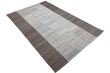 Rug with a light central band and brown-gray edges, woven square/tile pattern