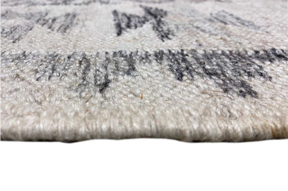 Close-up: kilim rug with fringe, light beige pile surface and dark blue patterns