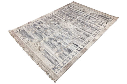 Kelim rug at an angle, blue-gray pattern, light border and fringe