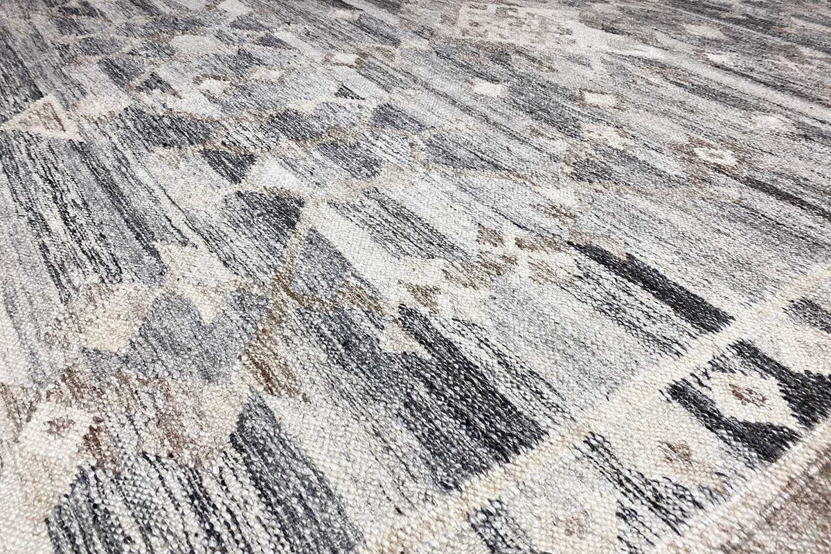 Details of the kilim rug: blue-gray texture and abstract pattern in the fabric