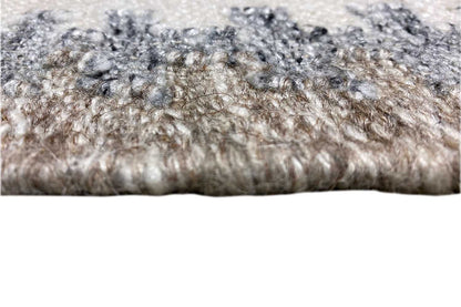 Close-up of the kilim dhurrie: short, textured surface and dotted edge with fringes