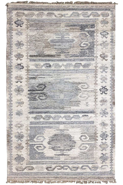 Modern kilim dhurrie rug with a geometric pattern, light gray-blue tones, and fringes