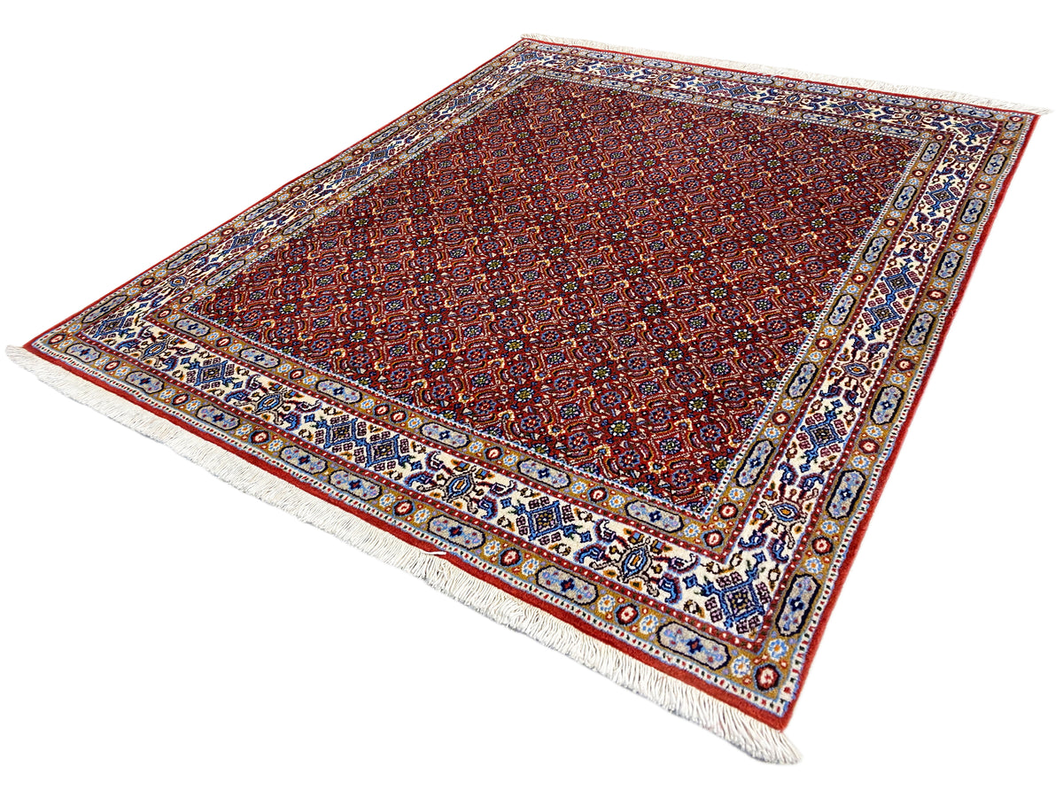 Oriental rug 132x122 cm, red fine pattern with blue-and-white decorative border and fringes