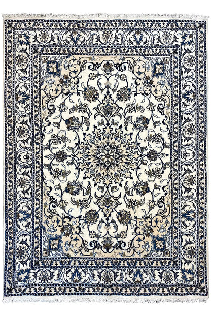 Rectangular blue-and-white Nain rug with an ornamental medallion, surrounding border, and finished edges.