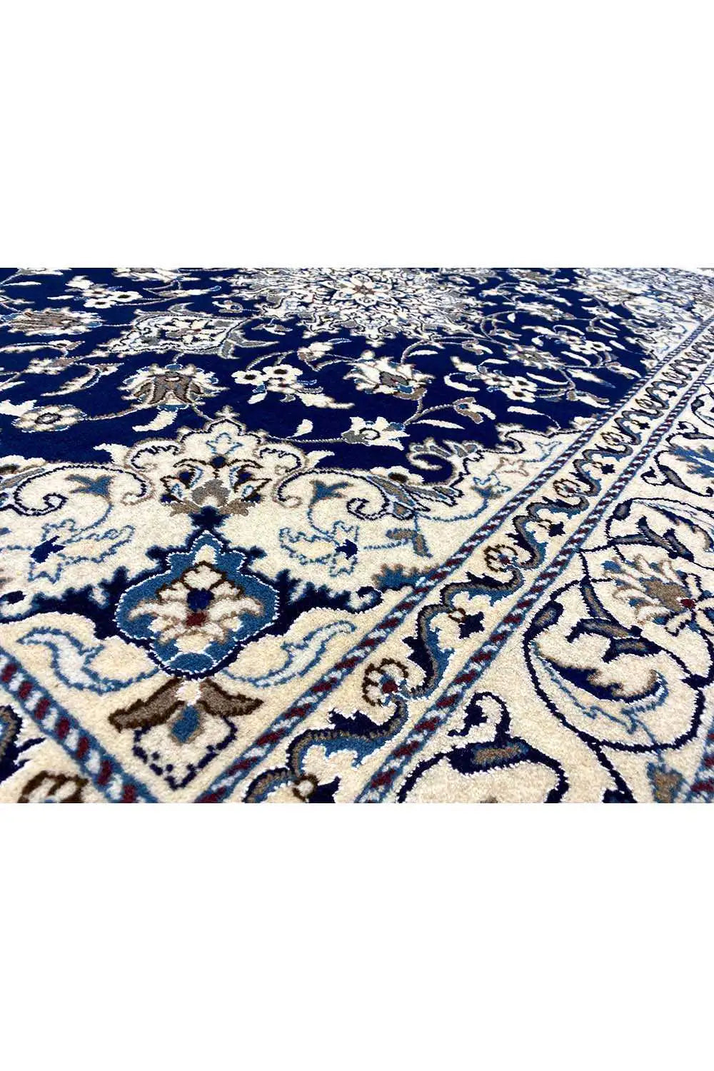 Detail of the Nain rug: blue field with floral ornaments and beige accents