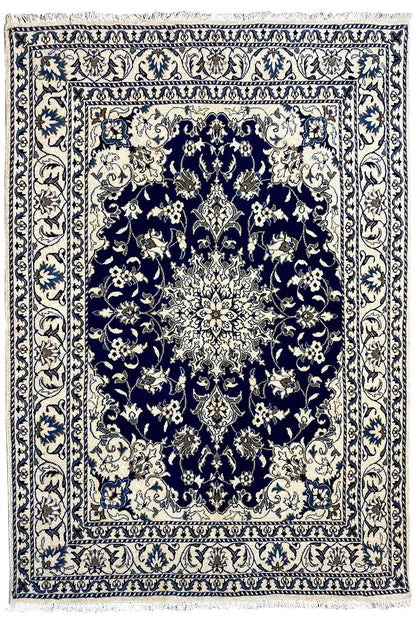 Nain rug with a symmetrical medallion pattern in blue and cream, wide ornamental border