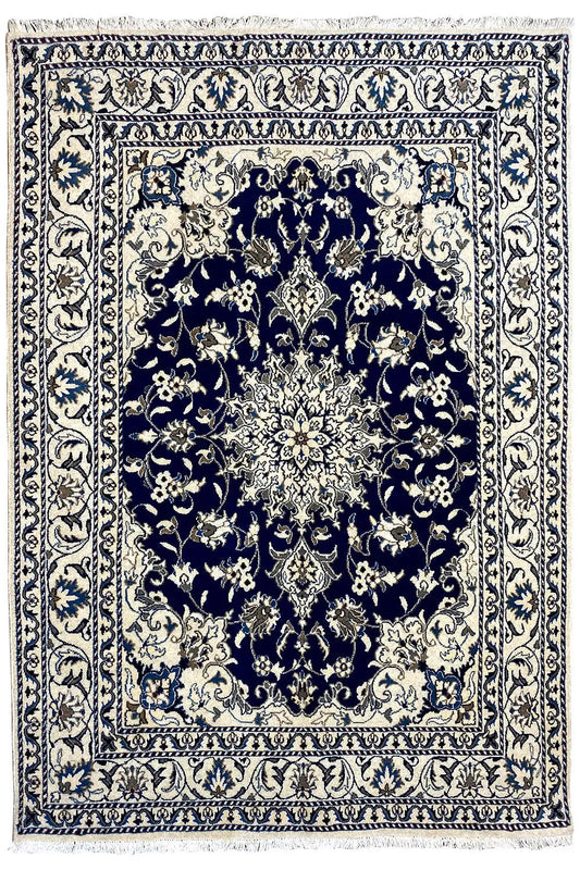 Nain rug with a symmetrical medallion pattern in blue and cream, wide ornamental border