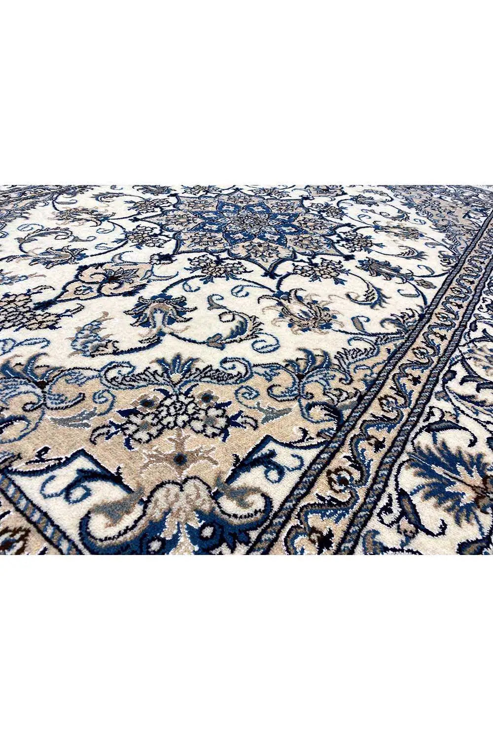 Close-up: blue-and-white floral pattern on a light background with a decorative border edge
