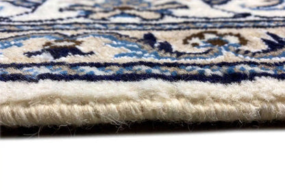 Close-up of the rug edge: short fringes and multicolored border threads