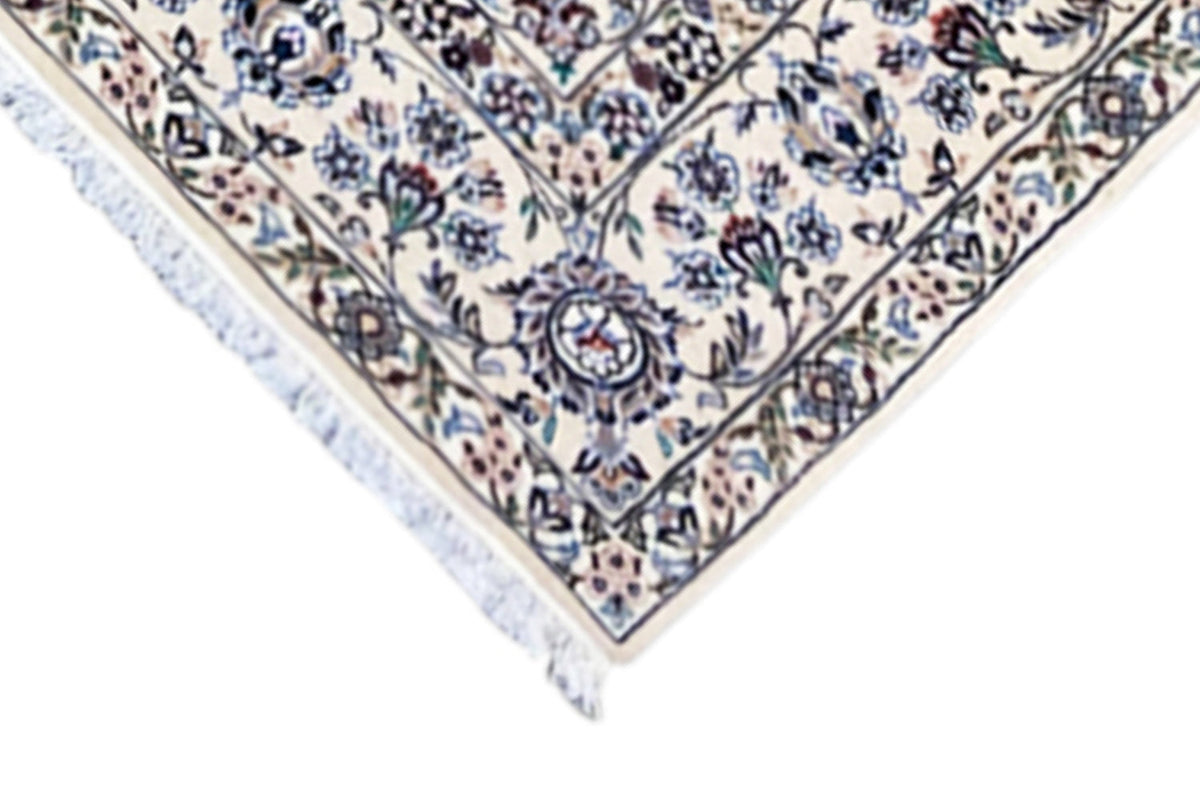 Nain rug detail at the corner: delicate vine ornaments, border line, and short fringes