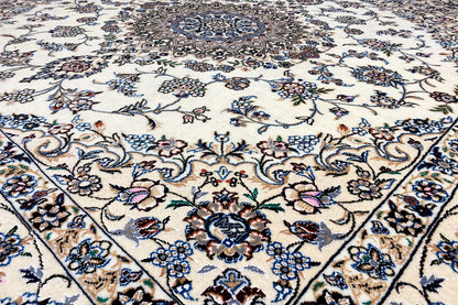 Close-up of a Nain rug: decorative floral and vine pattern in blue, beige, and brown