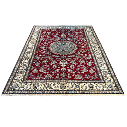 Rectangular Nain wool rug with a red central medallion and a wide ornamental border frame