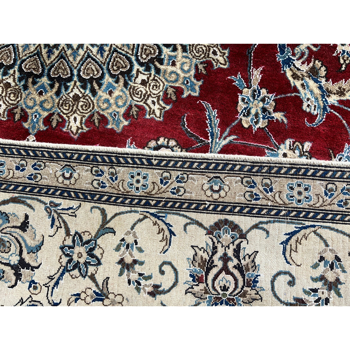 Close-up of border: red motif with blue floral elements and white-and-blue framing