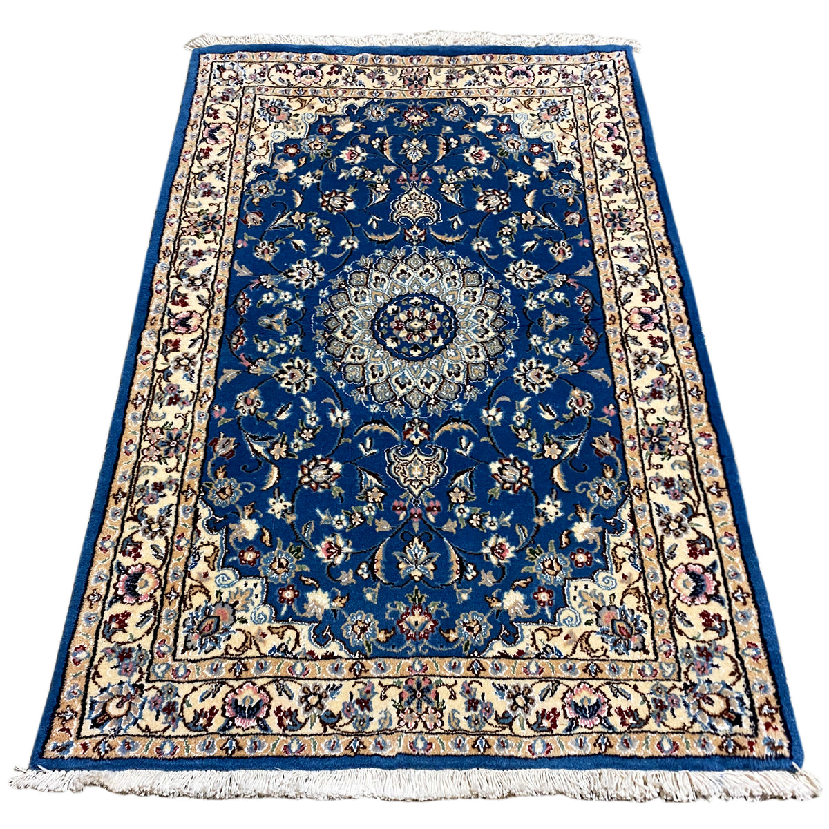 Blue Nain rug with medallion and floral ornaments, border, fringe.