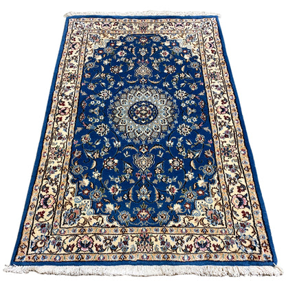 Blue Nain rug with medallion and floral ornaments, border, fringe.