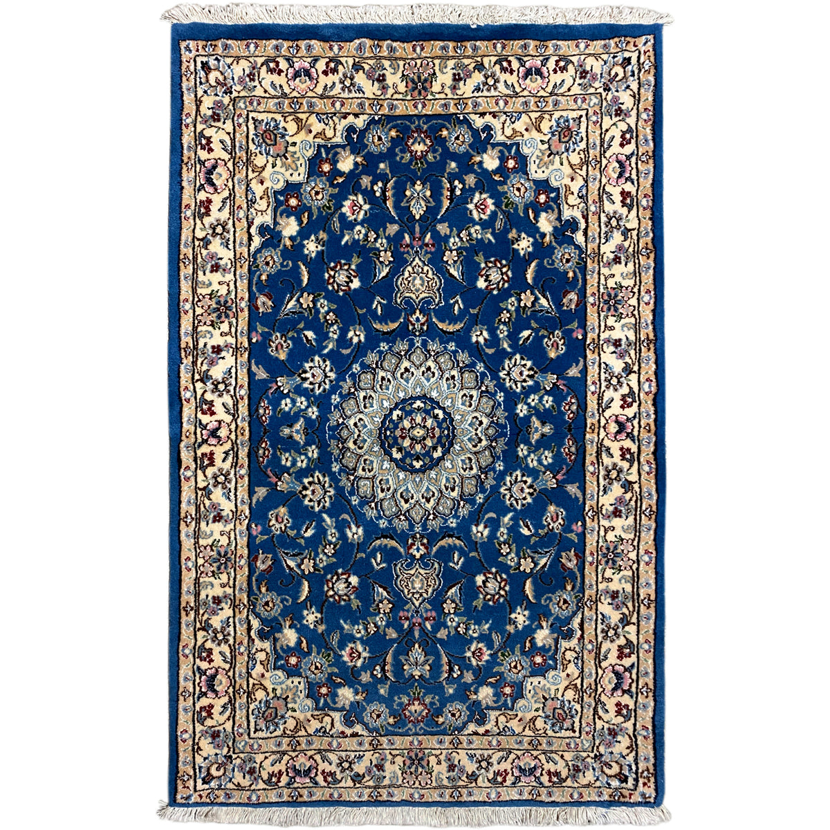 Blue Nain rug with medallion pattern, border and fringes.