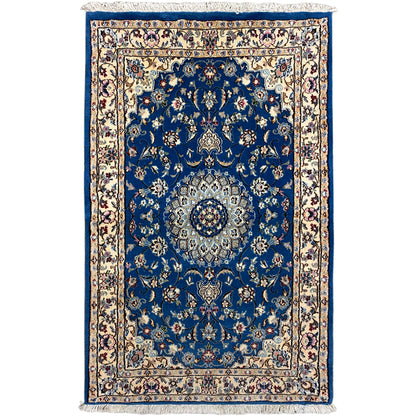Blue Nain rug with medallion pattern, border and fringes.