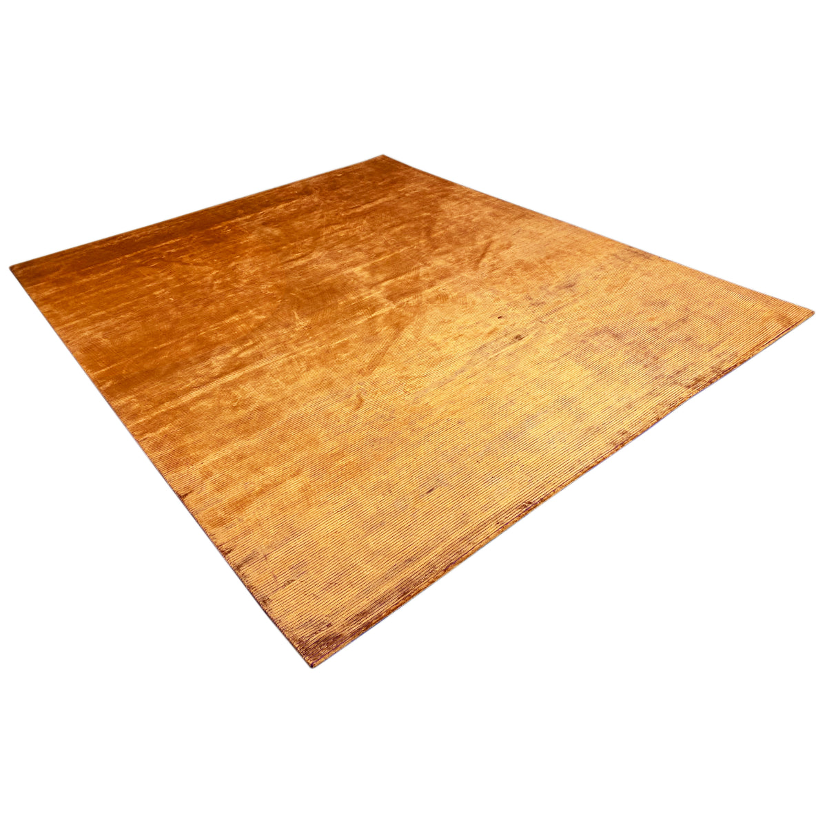 Carpet in golden orange with a velvety, flat relief texture and an even pile.