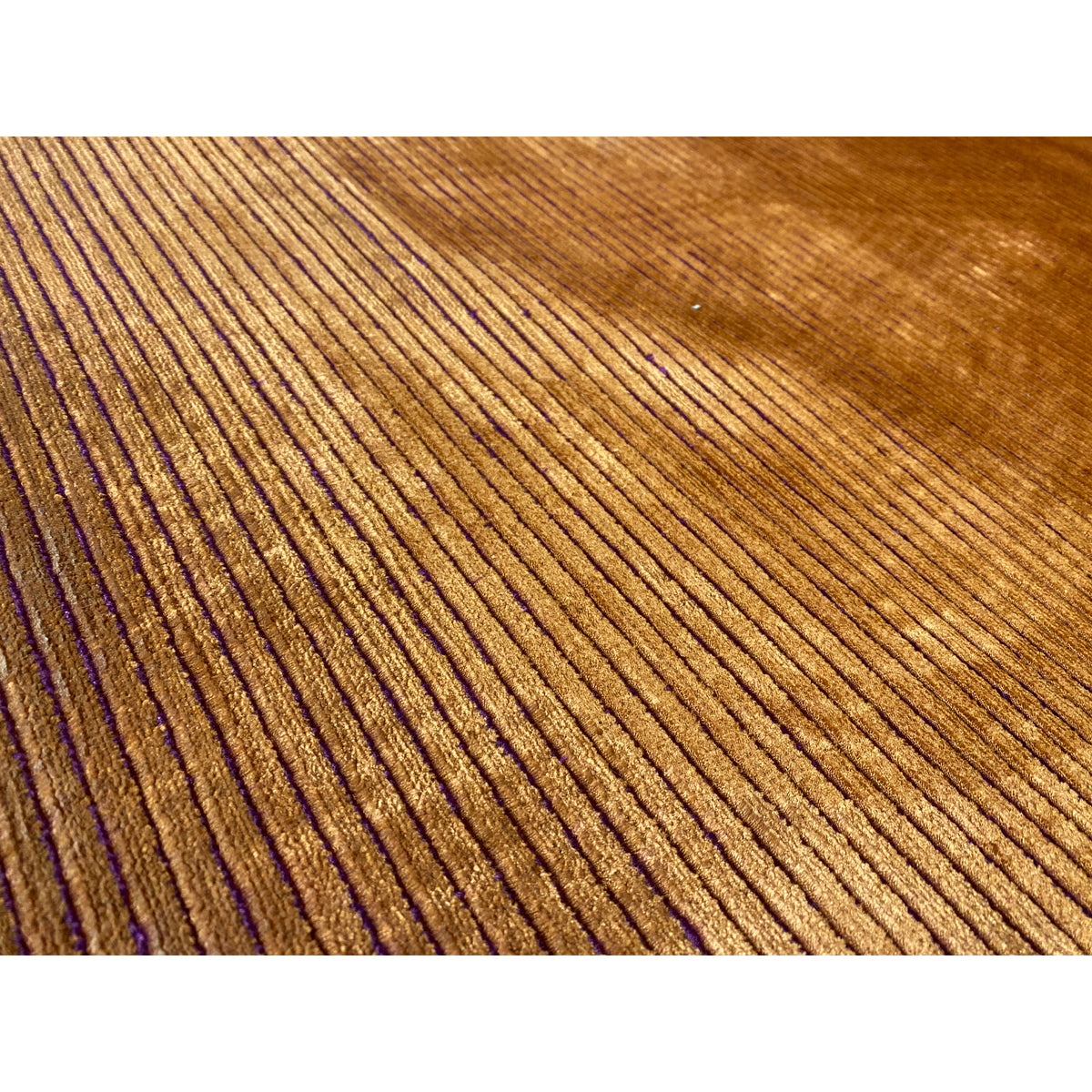 Carpet detail: yellow-brown pile with narrow purple vertical lines and a dense border.