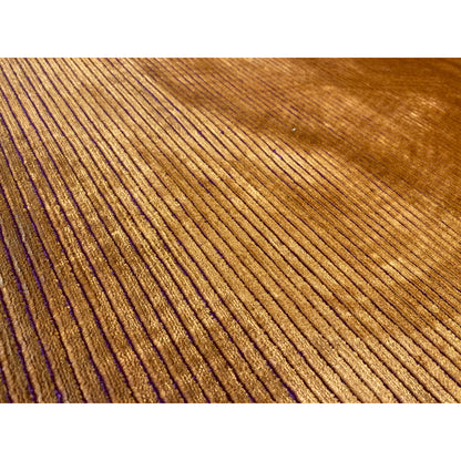 Carpet detail: yellow-brown pile with narrow purple vertical lines and a dense border.