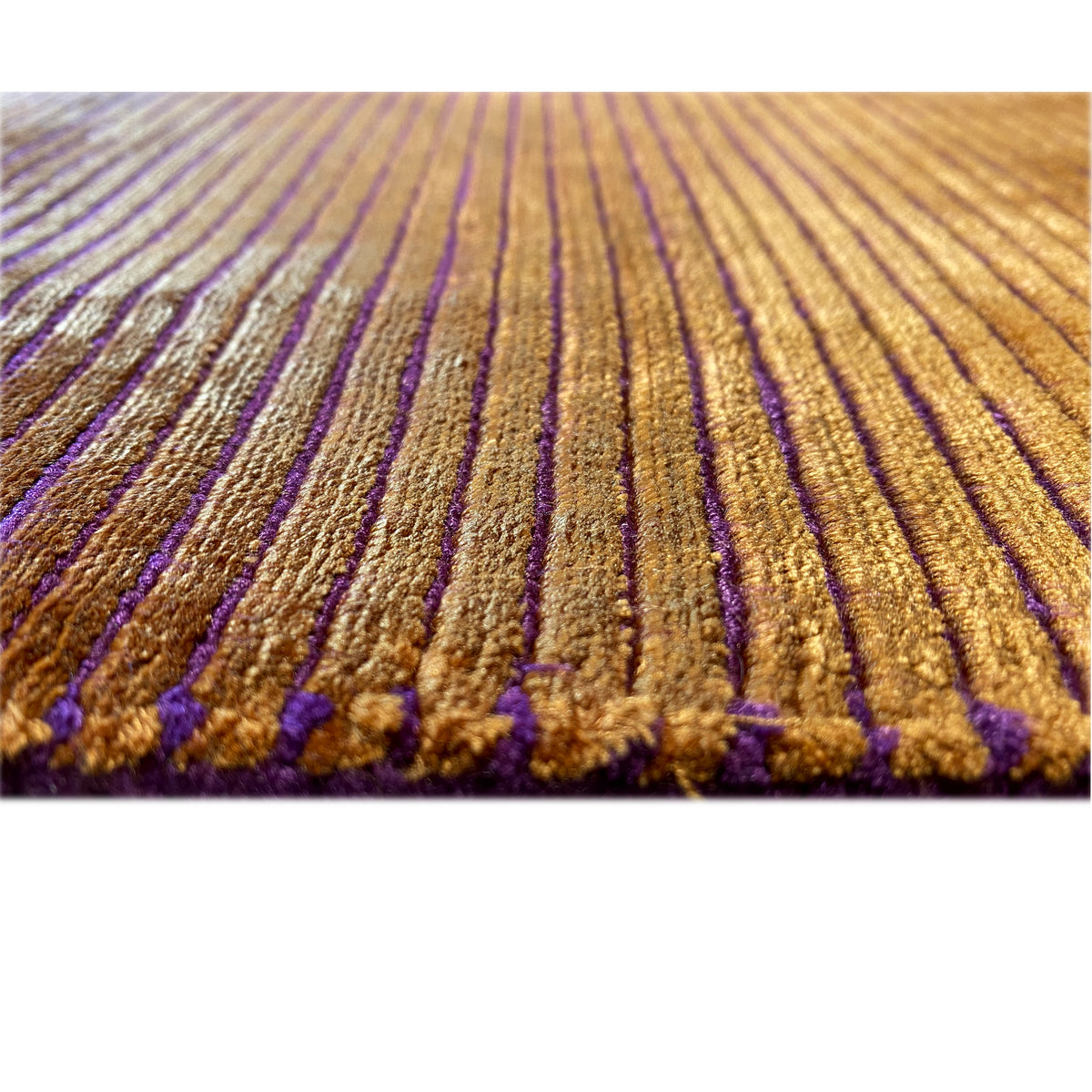 Carpet detail with yellow-brown longitudinal stripes and violet accents at the pile edge.
