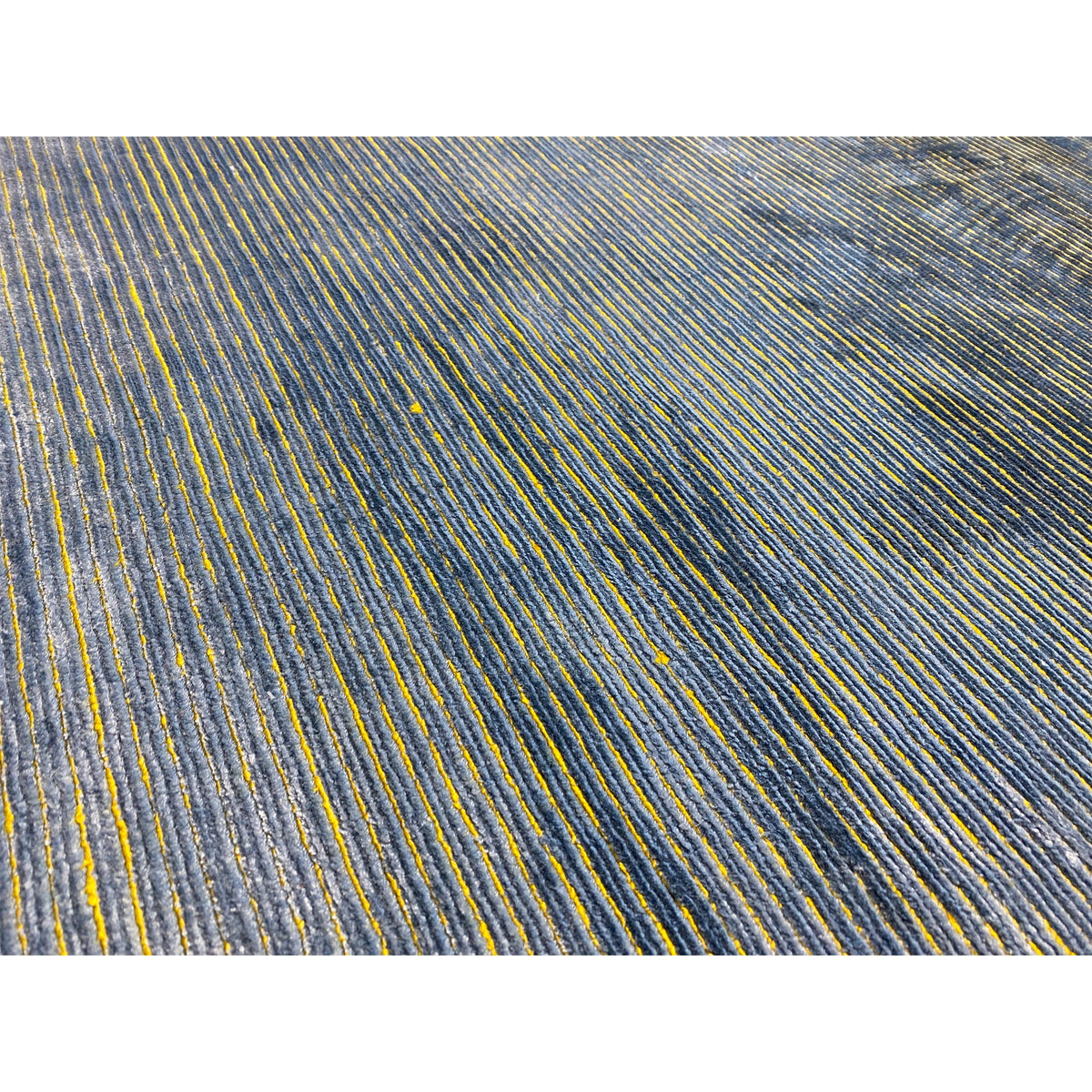 Close-up: Dense linear pattern in blue with yellow accents on short pile