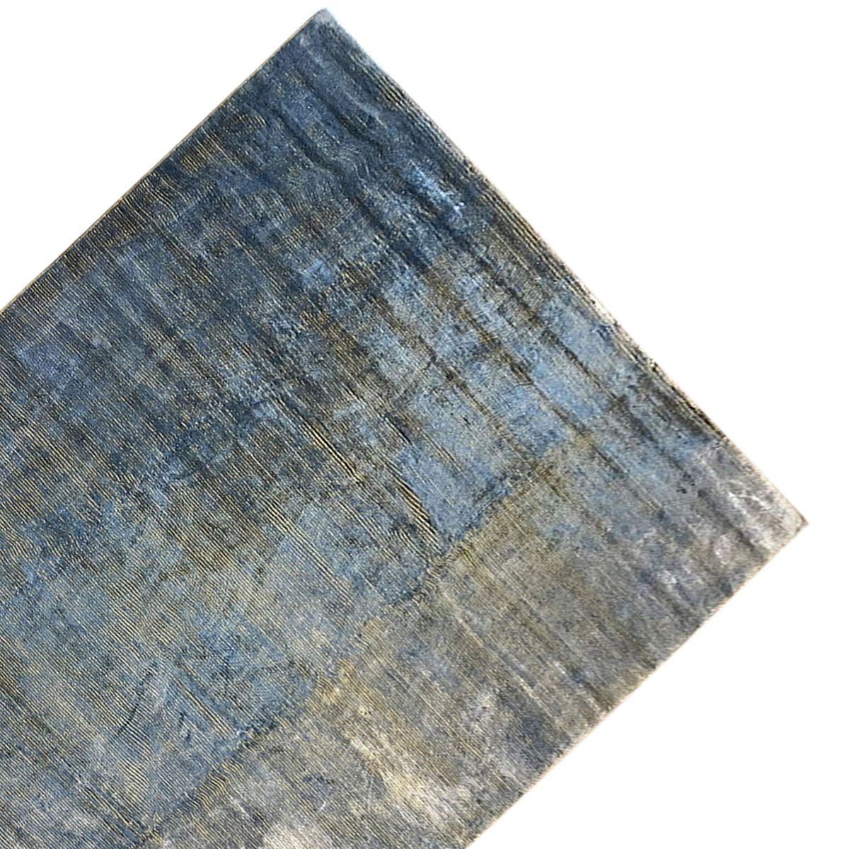 Carpet detail: blue-gray with a faded texture and diagonal color distribution